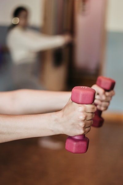 Armed with pink and white dumbbells
